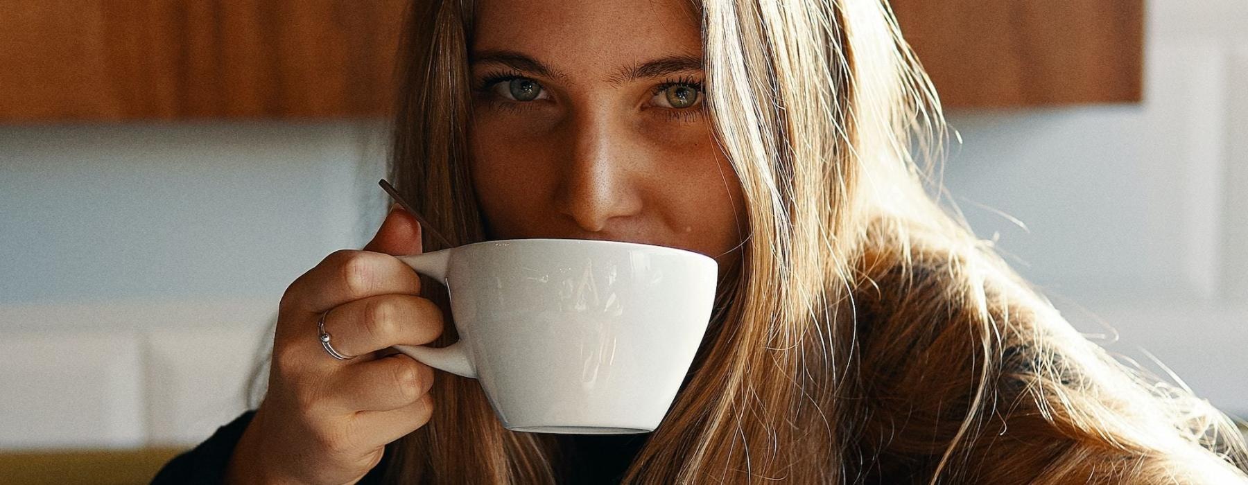 a person drinking from a cup