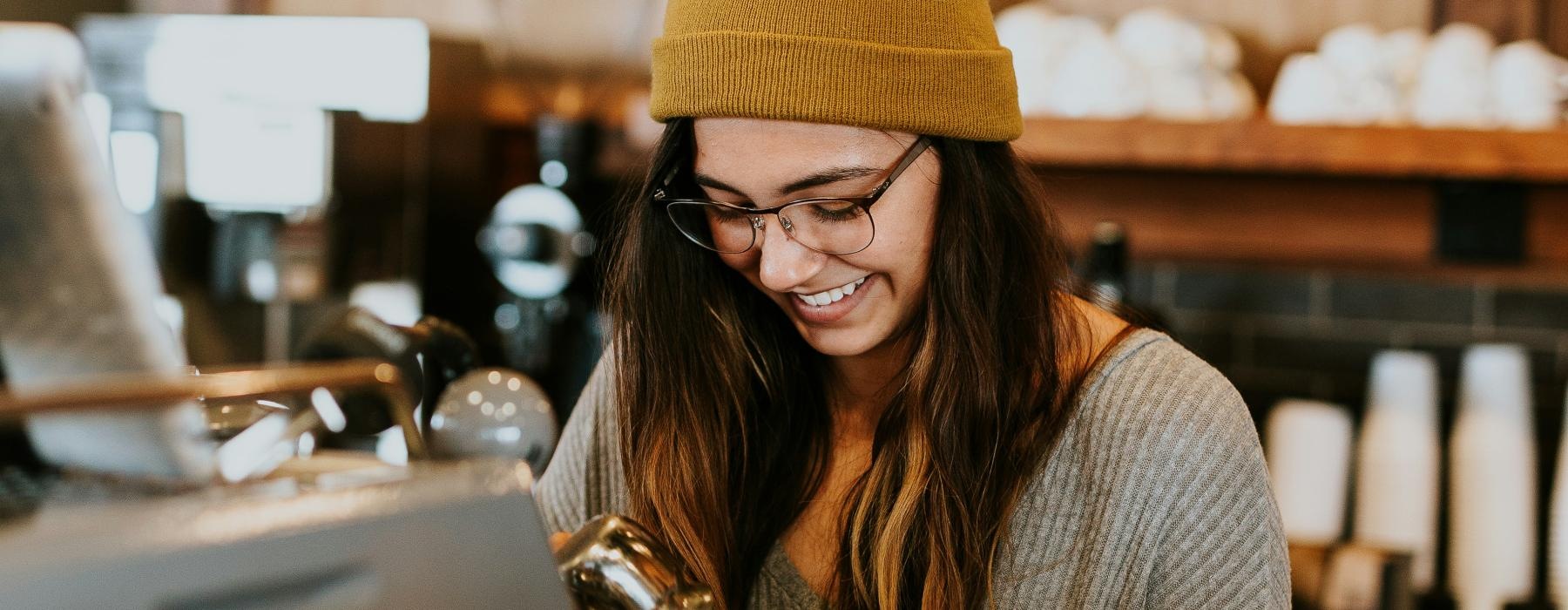 a woman in a hat making coffee